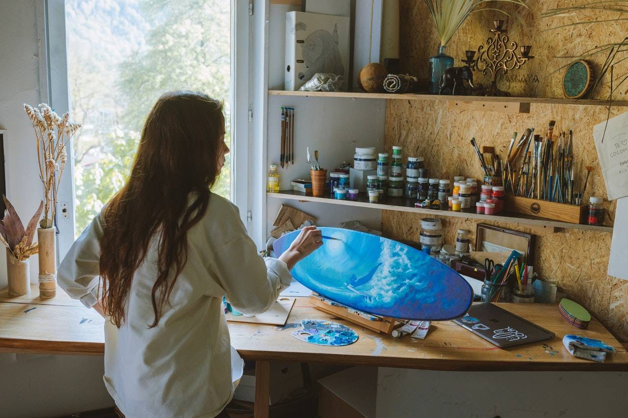  a woman painting a board as described by darren yaw wife